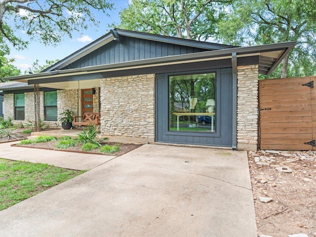 1907 Parkside Ln, Austin, TX 78745 - mid-century inspired home featuring a porch, stone siding, and board and batten siding