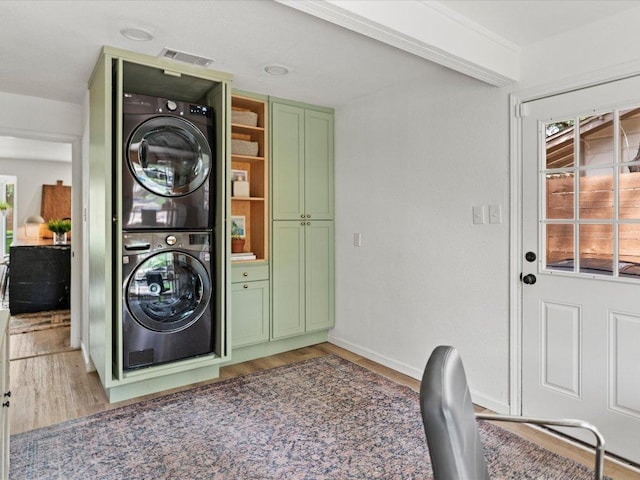 1907 Parkside Ln, Austin, TX 78745 - laundry room featuring stacked washer / drying machine, light wood-type flooring, and healthy amount of natural light