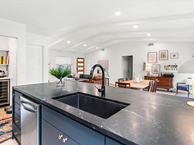 1907 Parkside Ln, Austin, TX 78745 - kitchen with vaulted ceiling, wine cooler, blue cabinetry, open floor plan, and recessed lighting