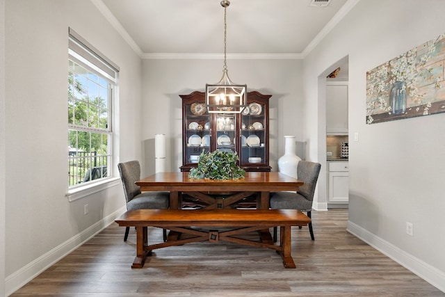 1304 Positano Pass, Leander, TX 78641 - dining room featuring a chandelier, plenty of natural light, ornamental molding, and light wood-type flooring