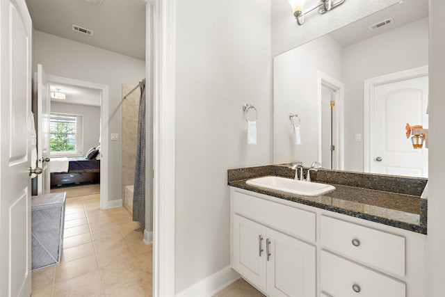 1304 Positano Pass, Leander, TX 78641 - full bathroom with vanity, tile patterned floors, curtained shower, and ensuite bathroom