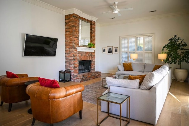4119 Hidden Canyon Cv, Austin, TX 78746 - living area with wood finished floors, ceiling fan, a brick fireplace, and ornamental molding
