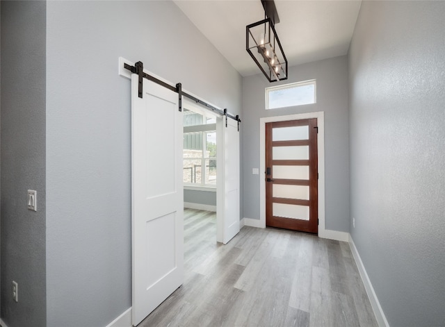 3013 Clark Ave, Lago Vista, TX 78645 - foyer entrance with a barn door and light wood finished floors