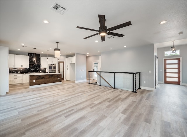 3013 Clark Ave, Lago Vista, TX 78645 - unfurnished living room featuring ceiling fan, recessed lighting, and light wood finished floors