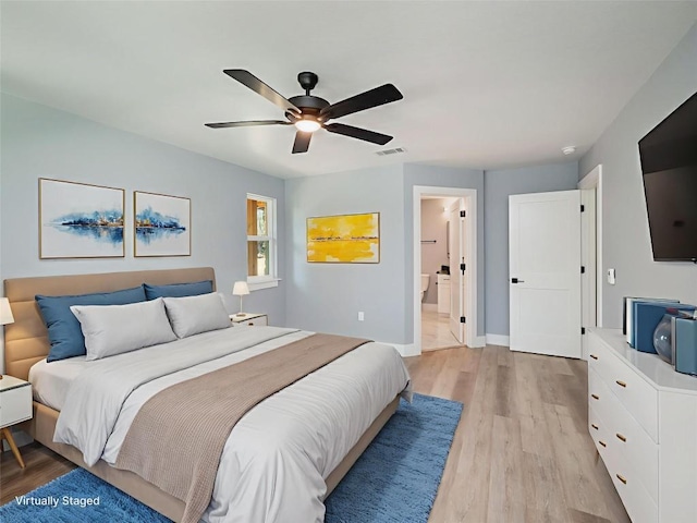 3013 Clark Ave, Lago Vista, TX 78645 - bedroom featuring light wood-style flooring, a ceiling fan, and ensuite bathroom