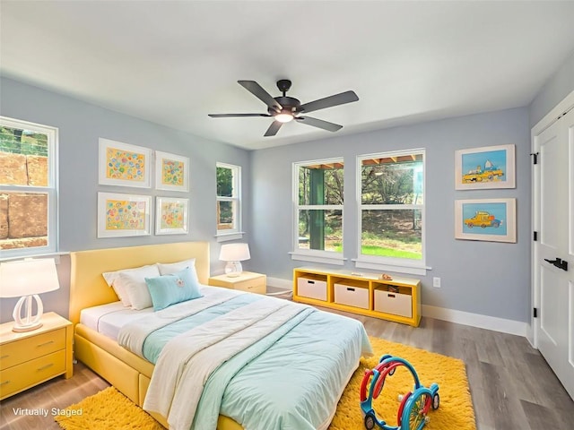 3013 Clark Ave, Lago Vista, TX 78645 - bedroom with multiple windows, wood finished floors, and ceiling fan