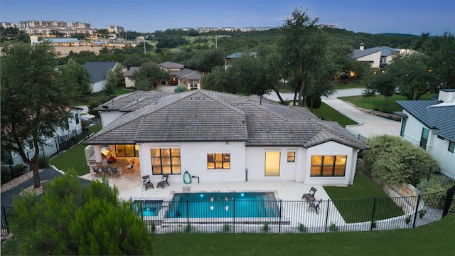 209 Ringtail Stream Dr, Lakeway, TX 78738 - back of property with a fenced backyard, stucco siding, and a patio