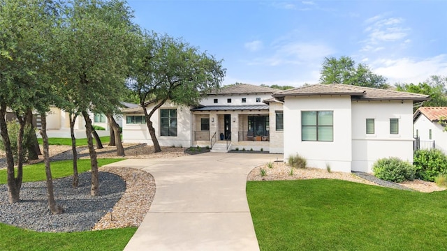 209 Ringtail Stream Dr, Lakeway, TX 78738 - view of front of home featuring stucco siding, a front lawn, a porch, and driveway