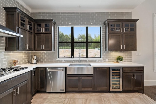 209 Ringtail Stream Dr, Lakeway, TX 78738 - kitchen with wine cooler, stainless steel appliances, wall chimney range hood, ornamental molding, and dark brown cabinets