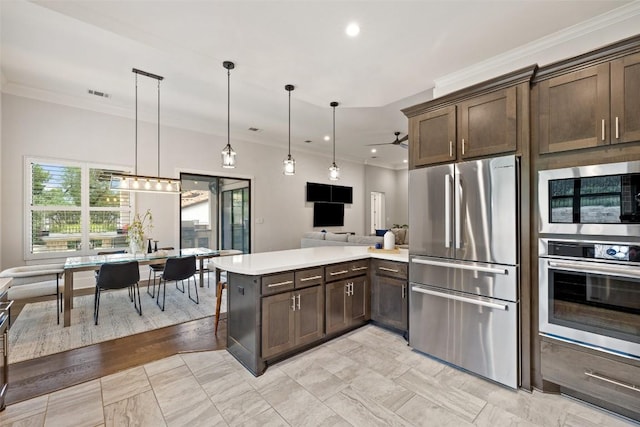 209 Ringtail Stream Dr, Lakeway, TX 78738 - kitchen with appliances with stainless steel finishes, a peninsula, dark brown cabinetry, crown molding, and light countertops