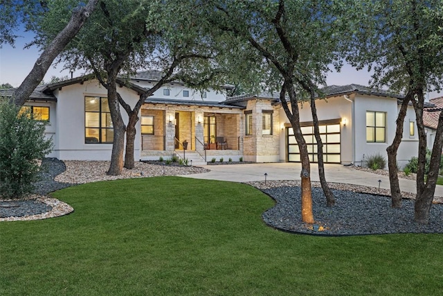 209 Ringtail Stream Dr, Lakeway, TX 78738 - view of front of property featuring a porch, concrete driveway, stucco siding, an attached garage, and stone siding