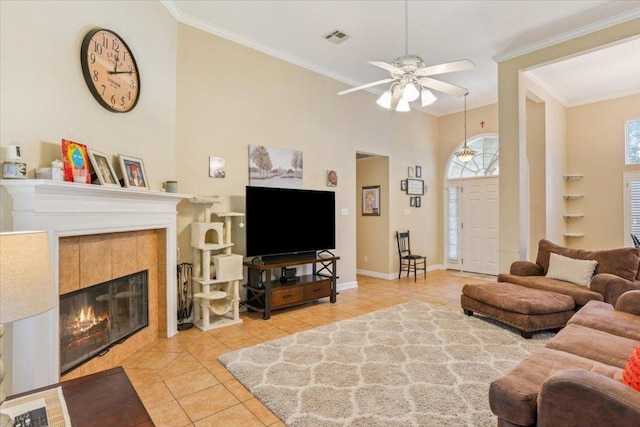 2802 Amber Forest Trl, Belton, TX 76513 - living area featuring light tile patterned floors, a ceiling fan, crown molding, and a fireplace