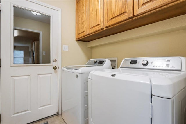 2802 Amber Forest Trl, Belton, TX 76513 - laundry room featuring washing machine and dryer, cabinet space, and light tile patterned flooring