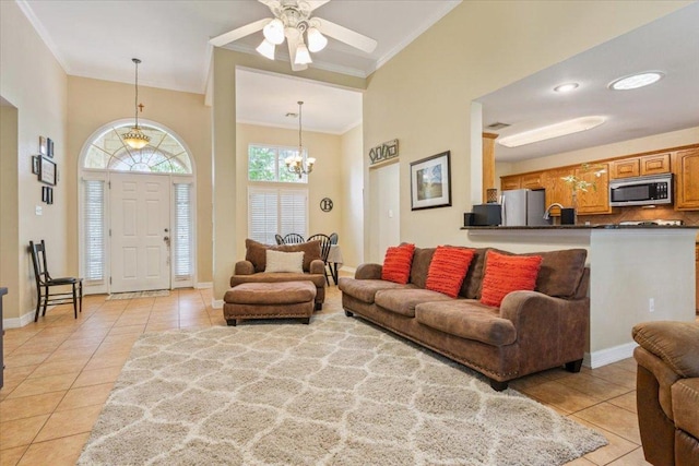 2802 Amber Forest Trl, Belton, TX 76513 - living area with ornamental molding, light tile patterned floors, ceiling fan, a chandelier, and a towering ceiling