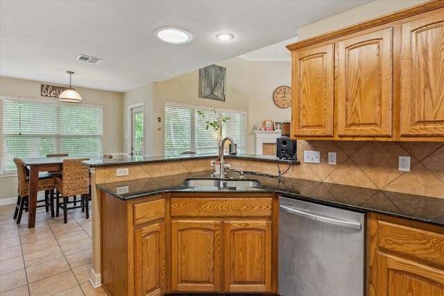 2802 Amber Forest Trl, Belton, TX 76513 - kitchen featuring stainless steel dishwasher, a peninsula, decorative backsplash, brown cabinetry, and light tile patterned flooring