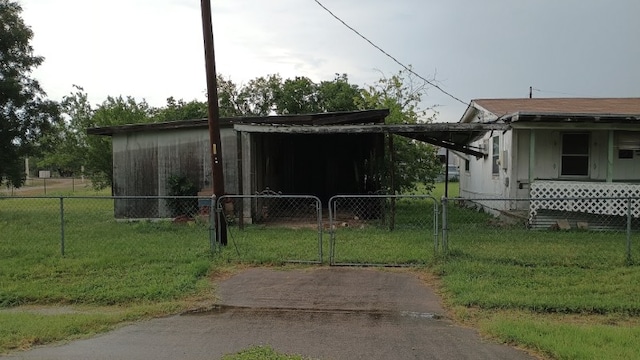 18016 Morrow St, Elgin, TX 78621 - view of side of property featuring a gate and an attached carport