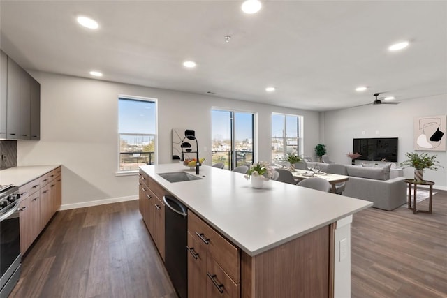 4510 Terry-O Ln Unit 322, Austin, TX 78745 - kitchen with dishwashing machine, dark wood-style flooring, light countertops, an island with sink, and open floor plan