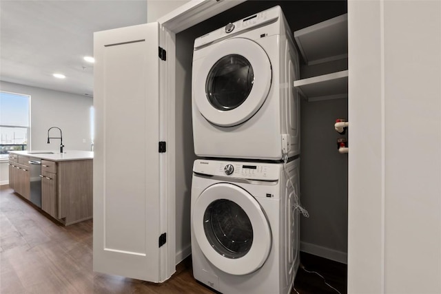 4510 Terry-O Ln Unit 322, Austin, TX 78745 - laundry area with estacked washer and dryer and wood finished floors
