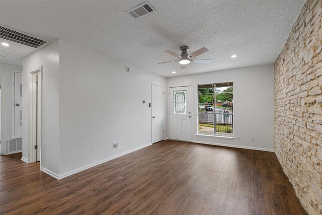 2616 Audubon Pl, Austin, TX 78741 - empty room featuring a ceiling fan, dark wood-type flooring, a textured ceiling, and recessed lighting