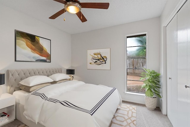 2616 Audubon Pl, Austin, TX 78741 - bedroom with multiple windows, light carpet, a closet, and a ceiling fan