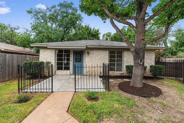 2616 Audubon Pl, Austin, TX 78741 - view of front facade with stone siding and a gate