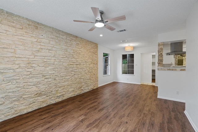 2616 Audubon Pl, Austin, TX 78741 - spare room with wood finished floors, a textured ceiling, and a ceiling fan