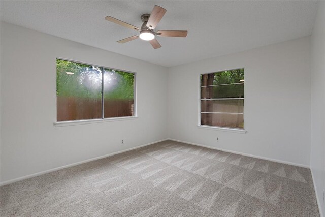 2616 Audubon Pl, Austin, TX 78741 - carpeted spare room with plenty of natural light and a ceiling fan