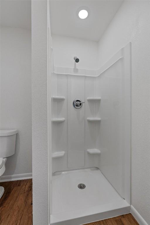 2616 Audubon Pl, Austin, TX 78741 - full bathroom with a stall shower and wood finished floors