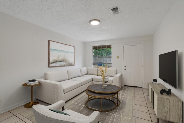 2616 Audubon Pl, Austin, TX 78741 - living area featuring light tile patterned floors and a textured ceiling