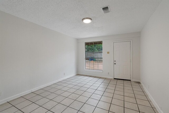 2616 Audubon Pl, Austin, TX 78741 - empty room featuring a textured ceiling and light tile patterned flooring