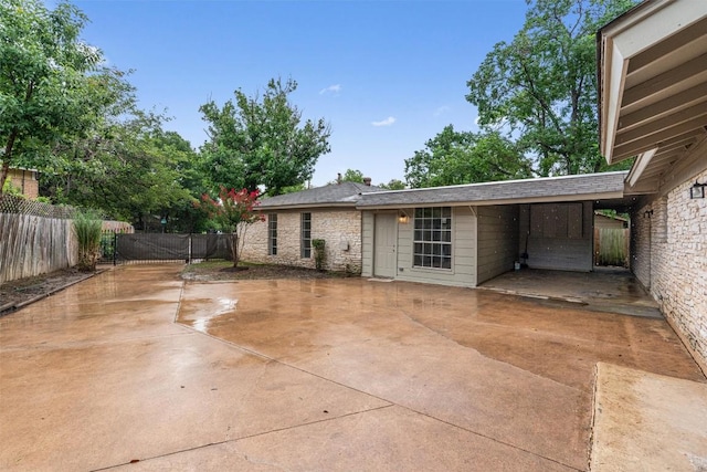 2616 Audubon Pl, Austin, TX 78741 - rear view of house featuring stone siding and a patio area