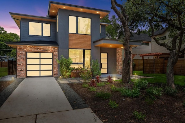 3005 French Pl, Austin, TX 78722 - contemporary home featuring a garage, driveway, and brick siding