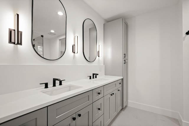 3005 French Pl, Austin, TX 78722 - bathroom featuring marble look tiles, double vanity, and recessed lighting