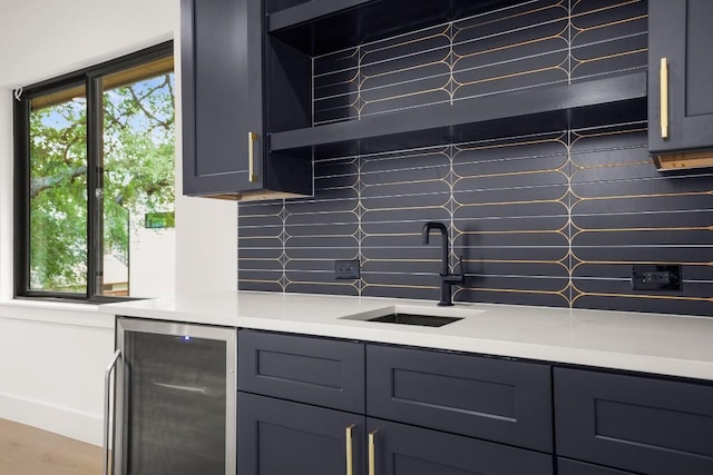3005 French Pl, Austin, TX 78722 - kitchen with beverage cooler, tasteful backsplash, light countertops, and gray cabinets
