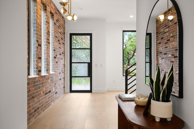 3005 French Pl, Austin, TX 78722 - foyer featuring brick wall, stairs, light wood-style floors, recessed lighting, and a chandelier