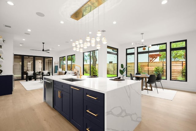 3005 French Pl, Austin, TX 78722 - kitchen with recessed lighting, healthy amount of natural light, light wood-type flooring, dishwasher, and an island with sink