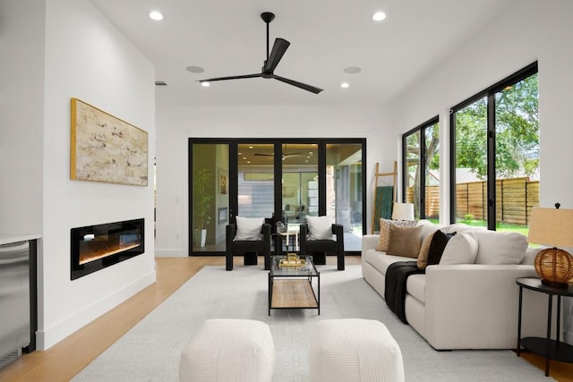 3005 French Pl, Austin, TX 78722 - living area featuring light wood-style flooring, a ceiling fan, a glass covered fireplace, and recessed lighting