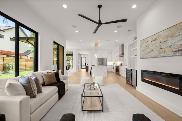 3005 French Pl, Austin, TX 78722 - living area with a ceiling fan, healthy amount of natural light, light wood-style floors, recessed lighting, and a glass covered fireplace