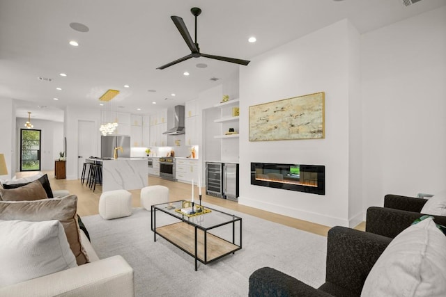 3005 French Pl, Austin, TX 78722 - living room with beverage cooler, light wood finished floors, recessed lighting, ceiling fan, and built in shelves