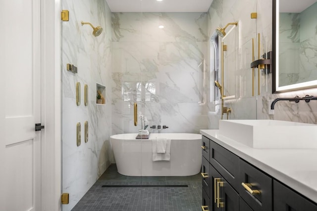 3005 French Pl, Austin, TX 78722 - full bath with tile walls, vanity, a freestanding bath, a marble finish shower, and tile patterned floors
