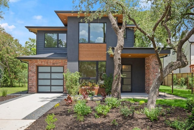 3005 French Pl, Austin, TX 78722 - contemporary home featuring driveway, brick siding, and an attached garage
