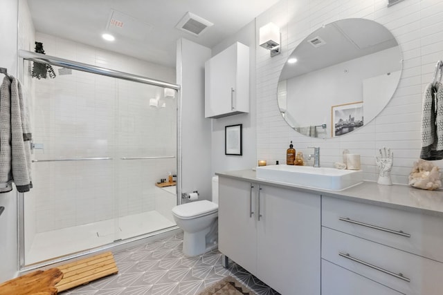 4004 Banister Ln Unit 105, Austin, TX 78704 - full bath with vanity, a shower stall, backsplash, and tile patterned floors
