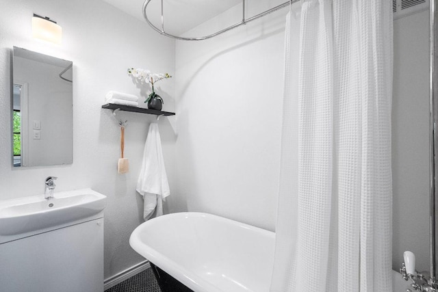 1703 Graywood Cv, Austin, TX 78704 - bathroom with a freestanding tub, vanity, and a shower with curtain