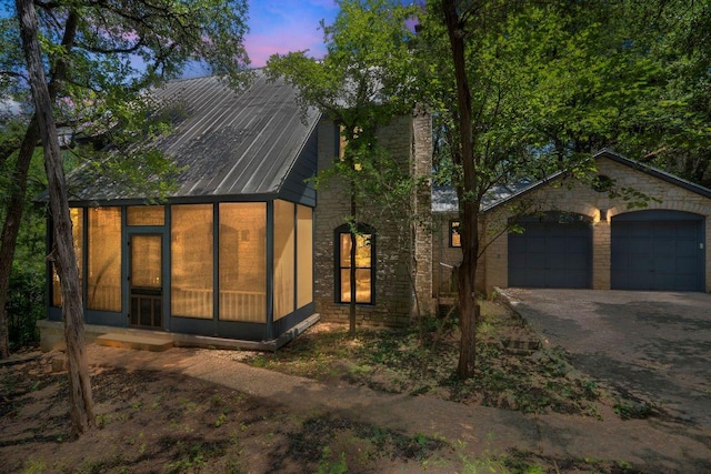 1703 Graywood Cv, Austin, TX 78704 - view of front of house with driveway, a garage, and a sunroom