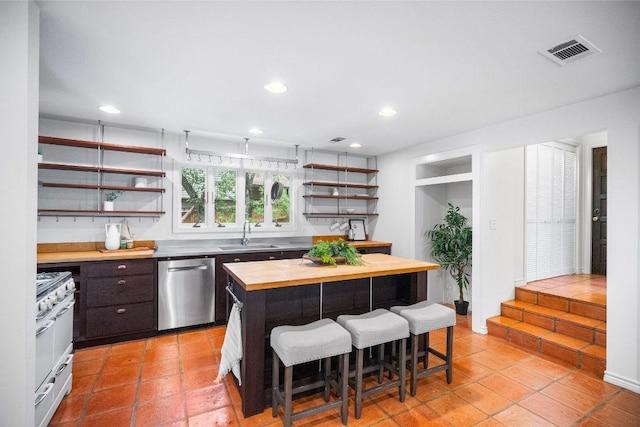 1703 Graywood Cv, Austin, TX 78704 - kitchen with wood counters, dishwasher, open shelves, a kitchen bar, and high end white range oven