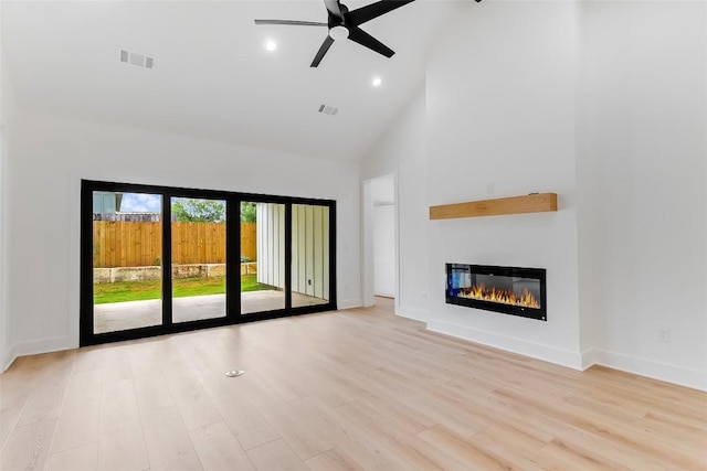 837 Birch Ln, Cottonwood Shores, TX 78657 - unfurnished living room with high vaulted ceiling, ceiling fan, a glass covered fireplace, wood finished floors, and recessed lighting