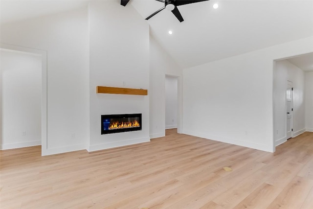837 Birch Ln, Cottonwood Shores, TX 78657 - unfurnished living room with a ceiling fan, high vaulted ceiling, a glass covered fireplace, light wood-type flooring, and recessed lighting
