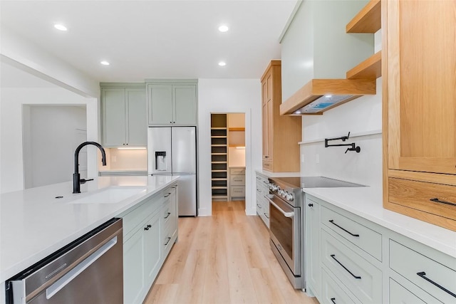 837 Birch Ln, Cottonwood Shores, TX 78657 - kitchen with high quality appliances, custom range hood, light wood finished floors, light countertops, and recessed lighting