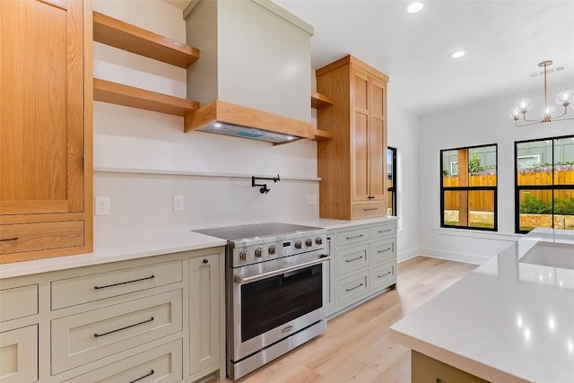 837 Birch Ln, Cottonwood Shores, TX 78657 - kitchen with high end stainless steel range oven, open shelves, premium range hood, light countertops, and light wood finished floors