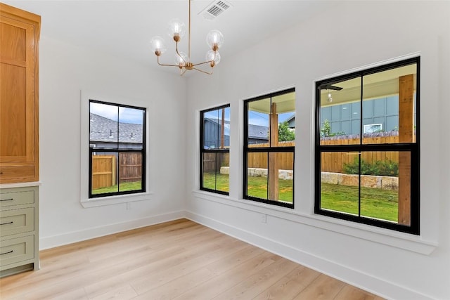 837 Birch Ln, Cottonwood Shores, TX 78657 - unfurnished dining area with a chandelier and light wood-style floors